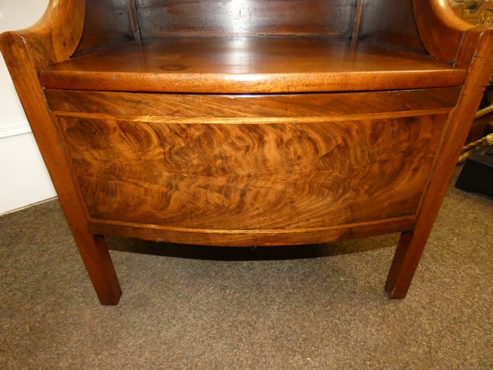 An antique Georgian mahogany bedside commode featuring an open upper shelf section with curved sides and a veneered lower cabinet. View VII