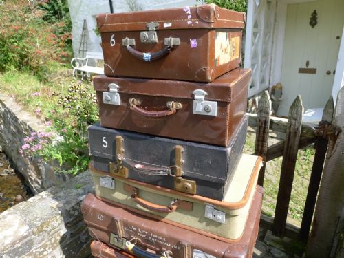 fig 1. 8 VINTAGE CASES INCLUDING LEATHER CARTRIDGE CASE AND A DE-MOB SUITCASE