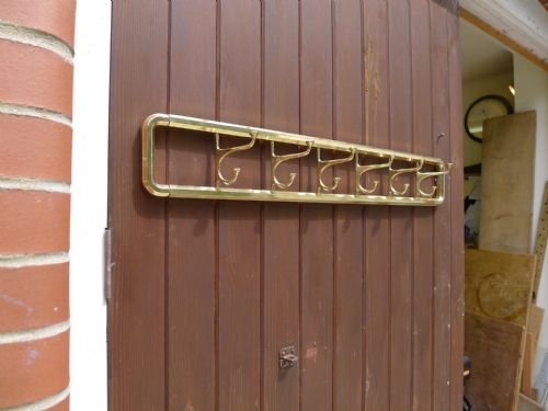 A Six Hook Swing Out Brass Coat and Hat Rack. Circa 1910