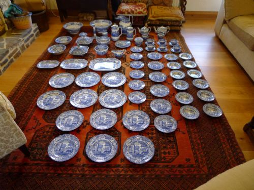 fig 1. An extensive antique Copeland Spode Italian pattern blue and white earthenware dinner service laid out across a red patterned rug.