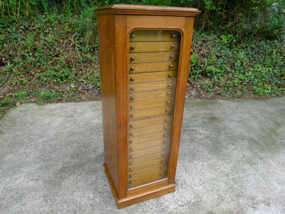 OAK 20 DRAWER COLLECTORS CABINET BY WATKINS AND DONCASTER, 36 THE STRAND, LONDON W.C.