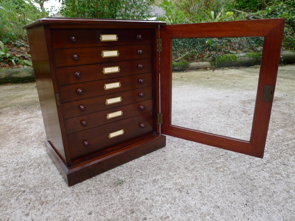 A 7 DRAWER MAHOGANY AND DEAL COLLECTORS CABINET BY J.T.CROCKETT OF LONDON. CIRCA 1900.