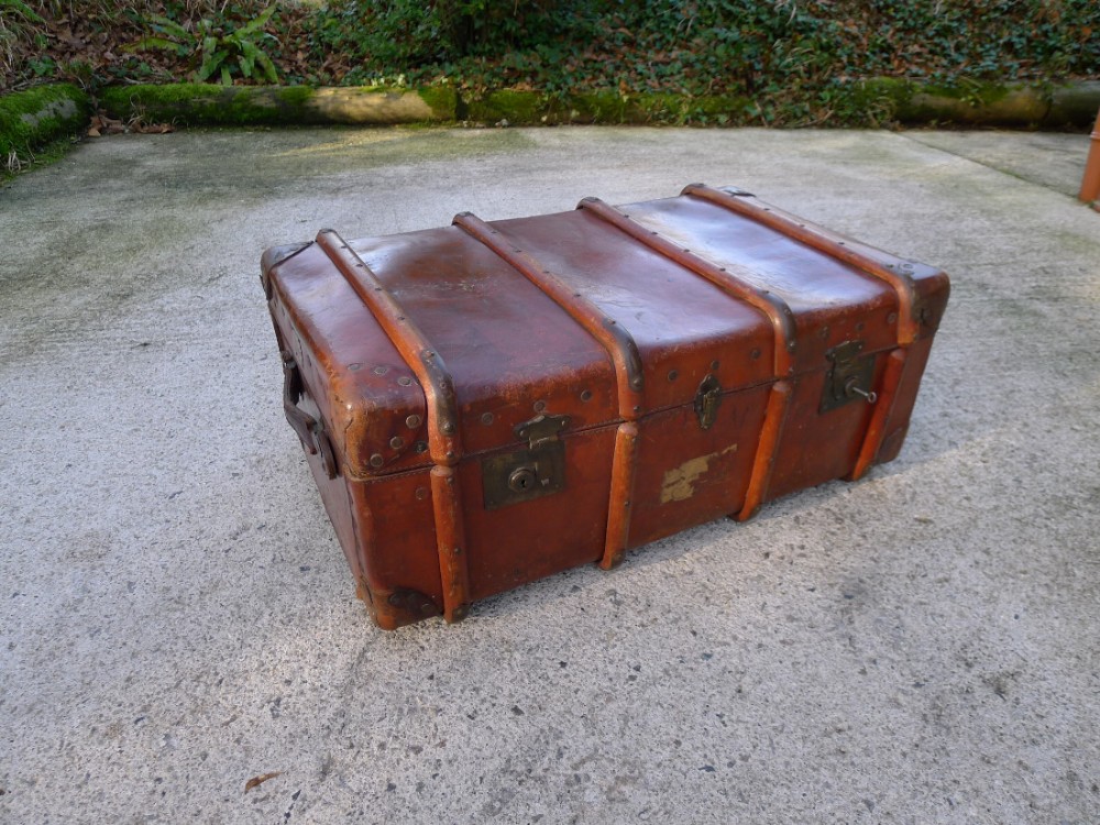 A LEATHER TRAVELLING TRUNK