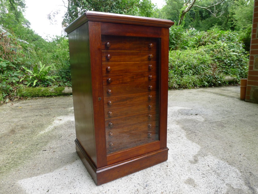 A FINE 12 DRAWER HONDURAS MAHOGANY COLLECTORS CABINET BY MESSRS WATKINS AND DONCASTER. THE STRAND. LONDON. CIRCA 1890