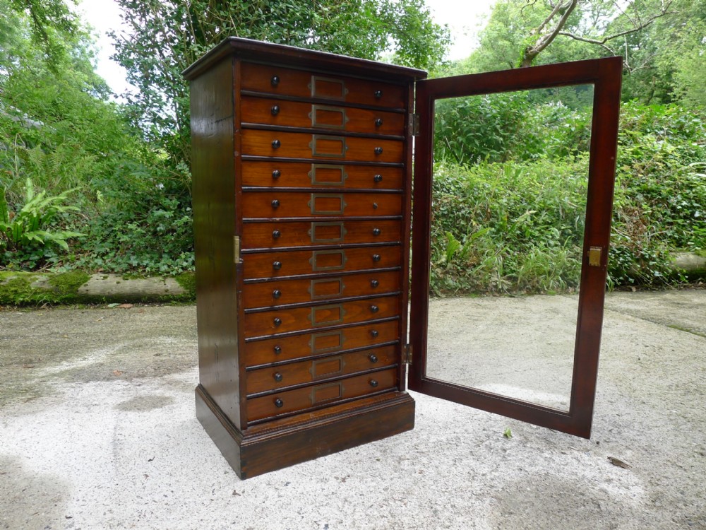 A 12 DRAWER COLLECTORS CABINET IN STAINED AND POLISHED DEAL BY GARDNER OF OXFORD STREET. LONDON. CIRCA 1890.