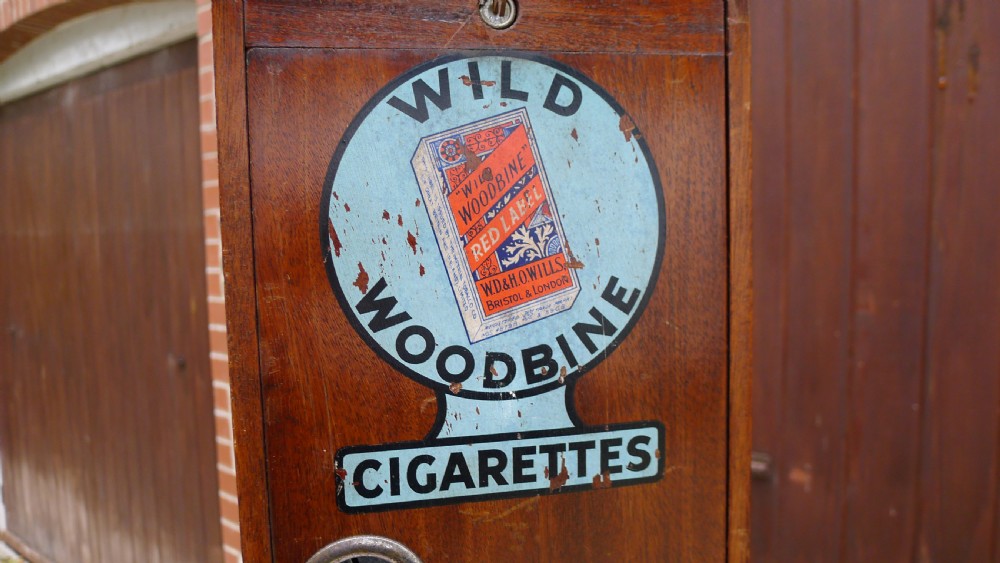 A 'WILD WOODBINE' CIGARETTE VENDING MACHINE IN FULL WORKING ORDER. CIRCA 1930. 3d A PACKET COMPLETE WITH OLD PENNIES!  View VI