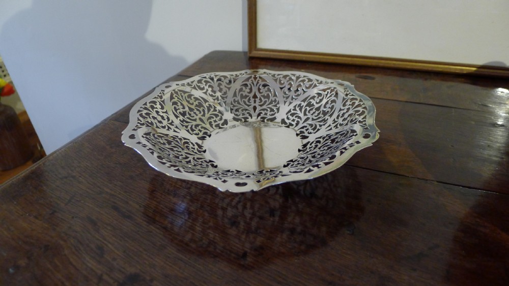 A PIERCED SILVER BON BON DISH BY S.J.LEVI BIRMINGHAM 1932.  View VII