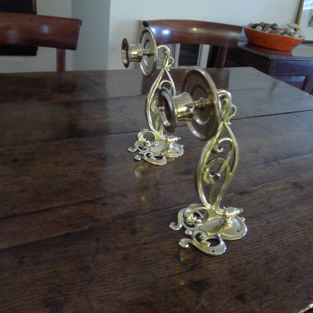 A BEAUTIFUL PAIR OF BRASS, SWING OUT PIANO CANDLE HOLDERS. CIRCA 1890. View II