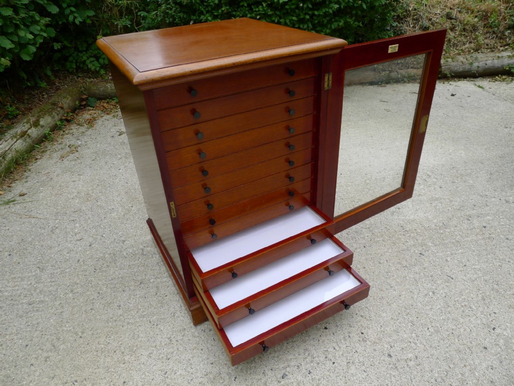 AN EXCELLENT 12 DRAWER MAHOGANY COLLECTORS CABINET BY MESSRS WATKINS & DONCASTER, 36 THE STRAND LONDON. BUTTERFLY MEDAL ETC.