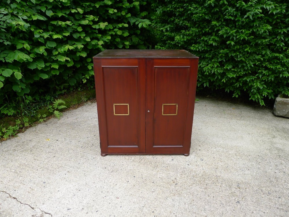 A mid-19th-century stained deal collectors cabinet featuring double doors opened to reveal twenty drawers with brass handles. View III
