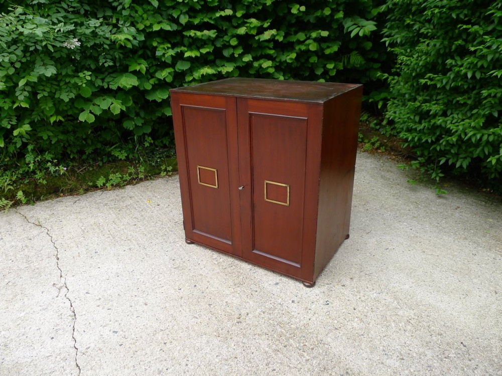 A mid-19th-century stained deal collectors cabinet featuring double doors opened to reveal twenty drawers with brass handles. View IV