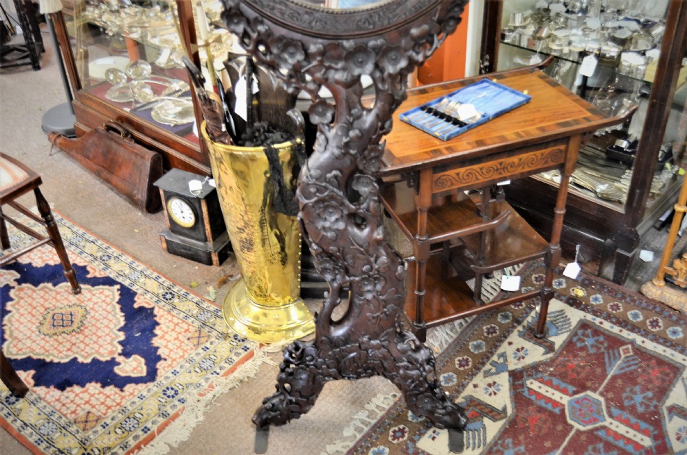 A 19th-century Chinese freestanding mirror featuring a circular glass face enclosed in a dark cherrywood frame carved with naturalistic prunus blossom branches. View III