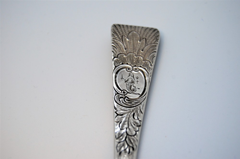 A pair of 18th-century Irish sterling silver spoons featuring embossed fruit and leaf designs in the bowls and chased pattern handles. View IV