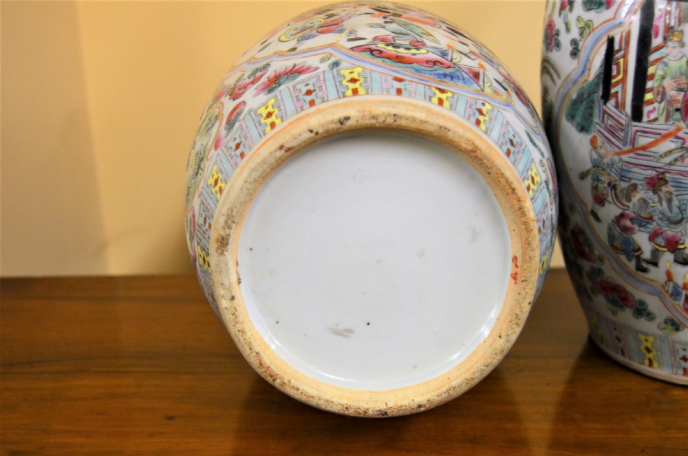 A pair of 19th-century Chinese Famille Rose porcelain baluster vases decorated with hand-painted narrative scenes inside cartouches and yellow pierced handles. View VI