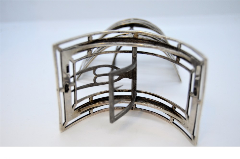 A pair of curved antique Irish silver shoe buckles with beaded borders and steel prongs. View IV