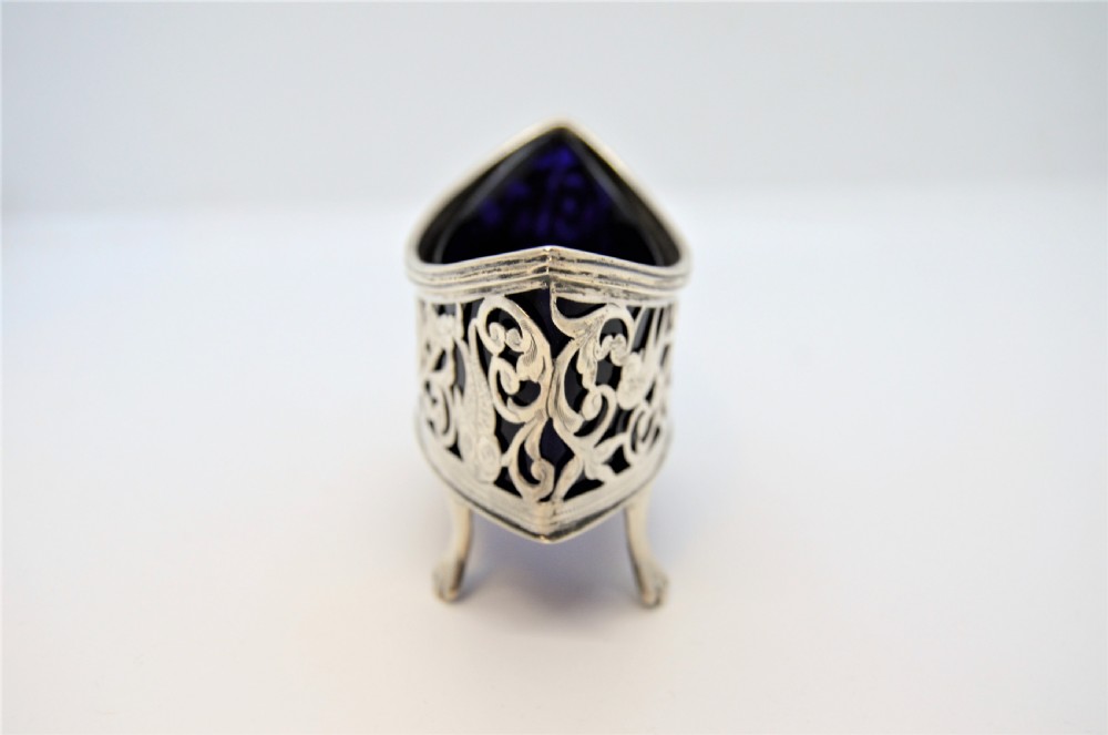 A pair of pierced silver open salt cellars raised on claw feet and fitted with deep cobalt blue glass liners. View III