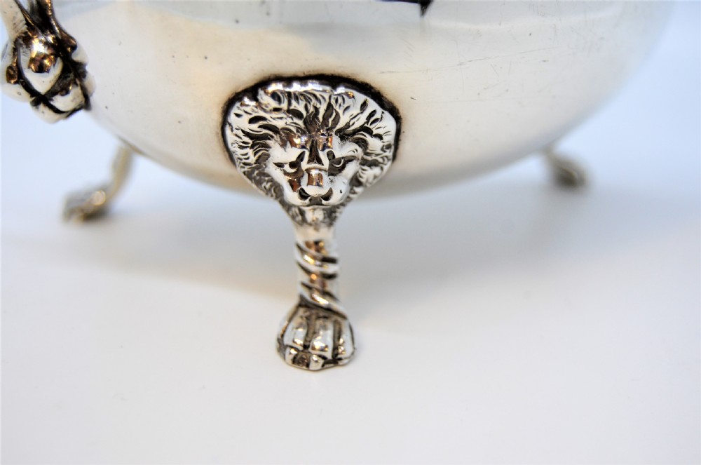 A polished sterling silver sauce boat featuring a serpent head handle, gadrooned rim, and three lion mask feet with visible hallmarks. View II
