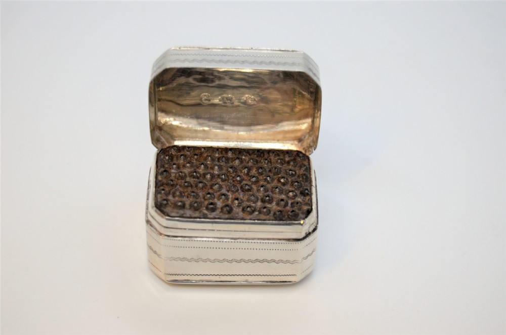 An engraved rectangular Georgian sterling silver nutmeg grater box with canted corners and acanthus leaf engraving. View II