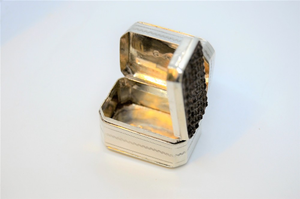 An engraved rectangular Georgian sterling silver nutmeg grater box with canted corners and acanthus leaf engraving. View III