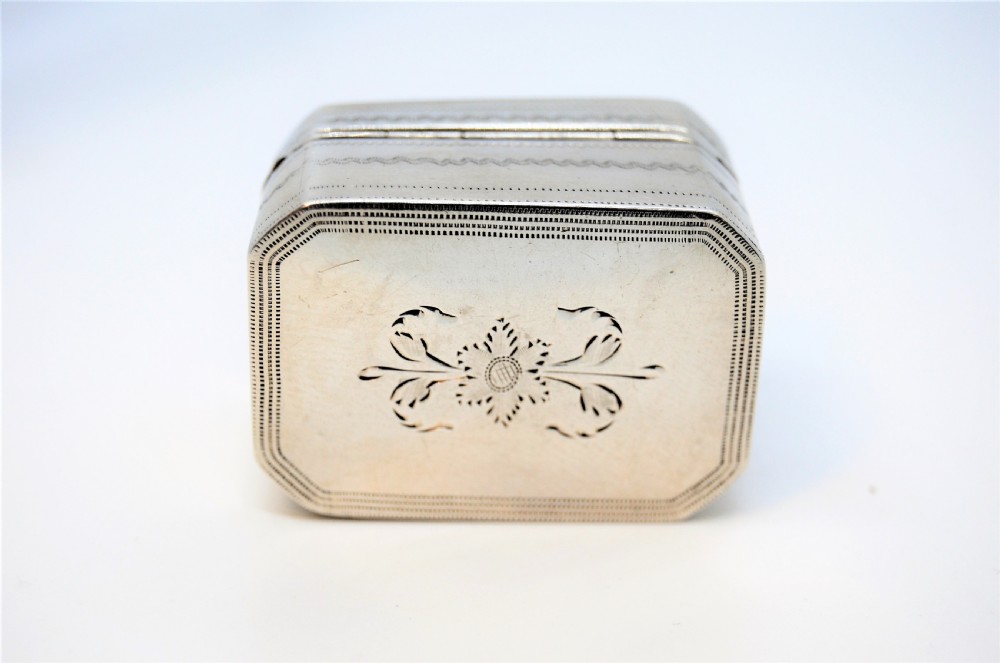 An engraved rectangular Georgian sterling silver nutmeg grater box with canted corners and acanthus leaf engraving. View IV