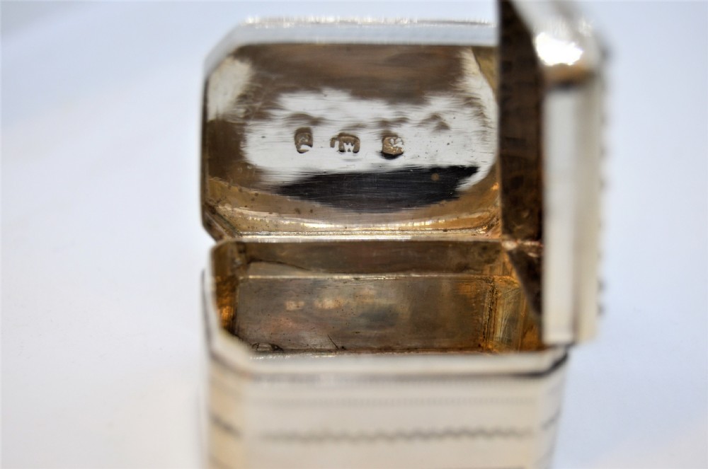 An engraved rectangular Georgian sterling silver nutmeg grater box with canted corners and acanthus leaf engraving. View V