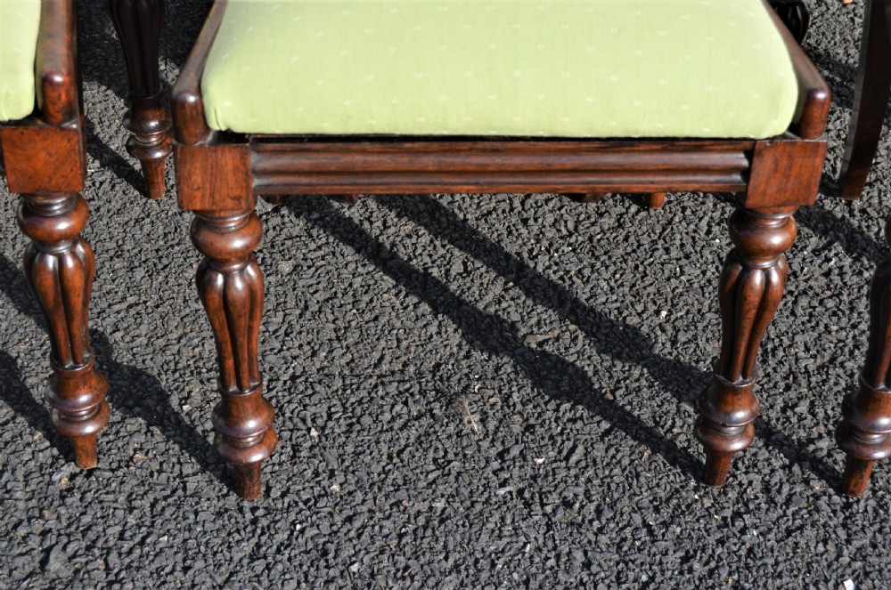 A set of six Victorian rosewood balloon-back dining chairs featuring carved cross-rails, turned front legs, and light green upholstered seats. View IV
