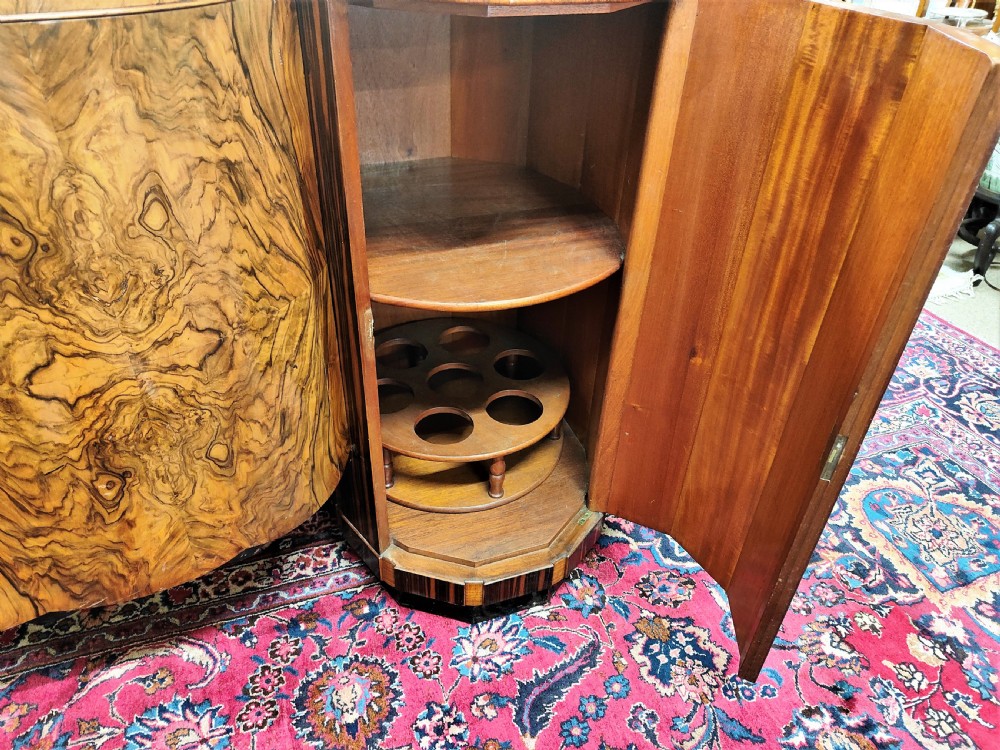 A French Art Deco eleven-piece dining suite comprising an oval dining table, matching high-back chairs, and sideboards featuring heavily figured calamander and macassar ebony veneers. View IV