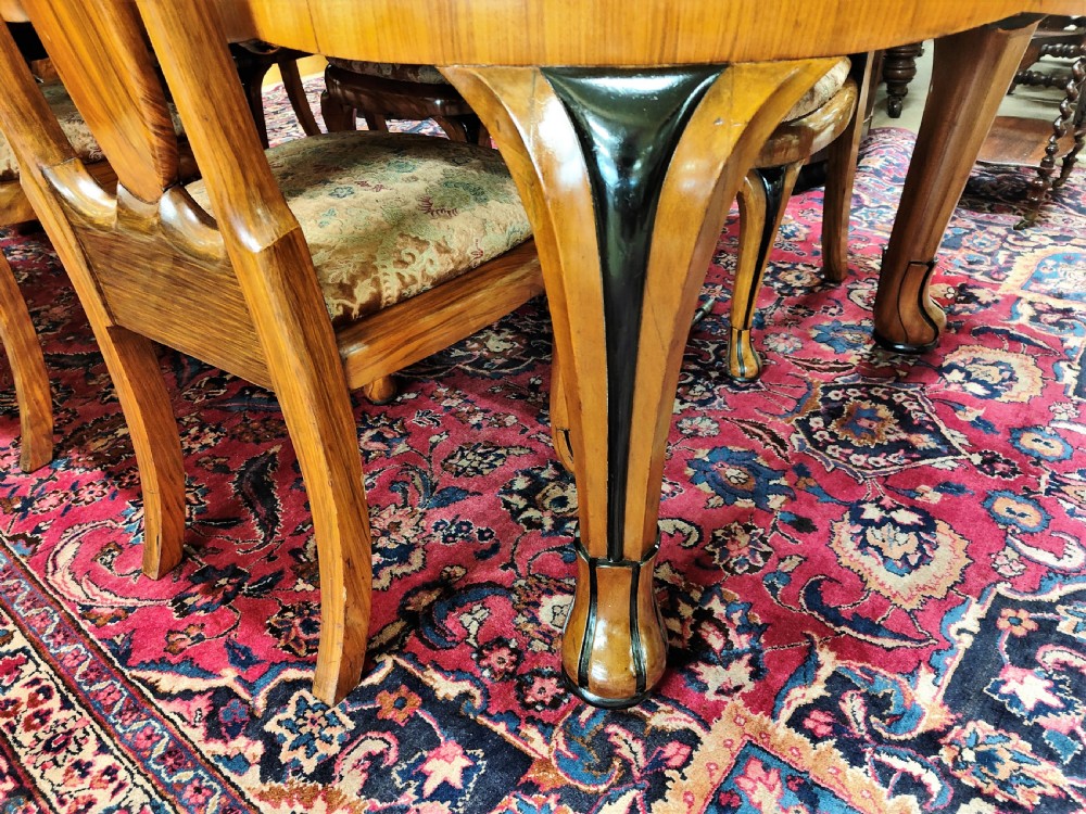A French Art Deco eleven-piece dining suite comprising an oval dining table, matching high-back chairs, and sideboards featuring heavily figured calamander and macassar ebony veneers. View VI
