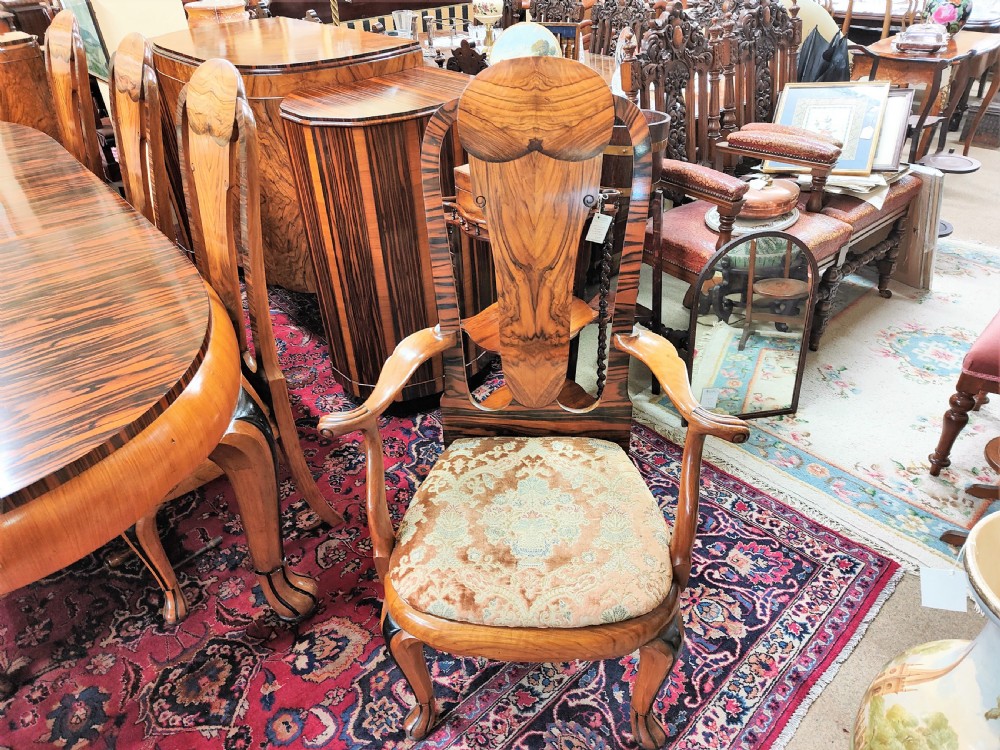 A French Art Deco eleven-piece dining suite comprising an oval dining table, matching high-back chairs, and sideboards featuring heavily figured calamander and macassar ebony veneers. View VII