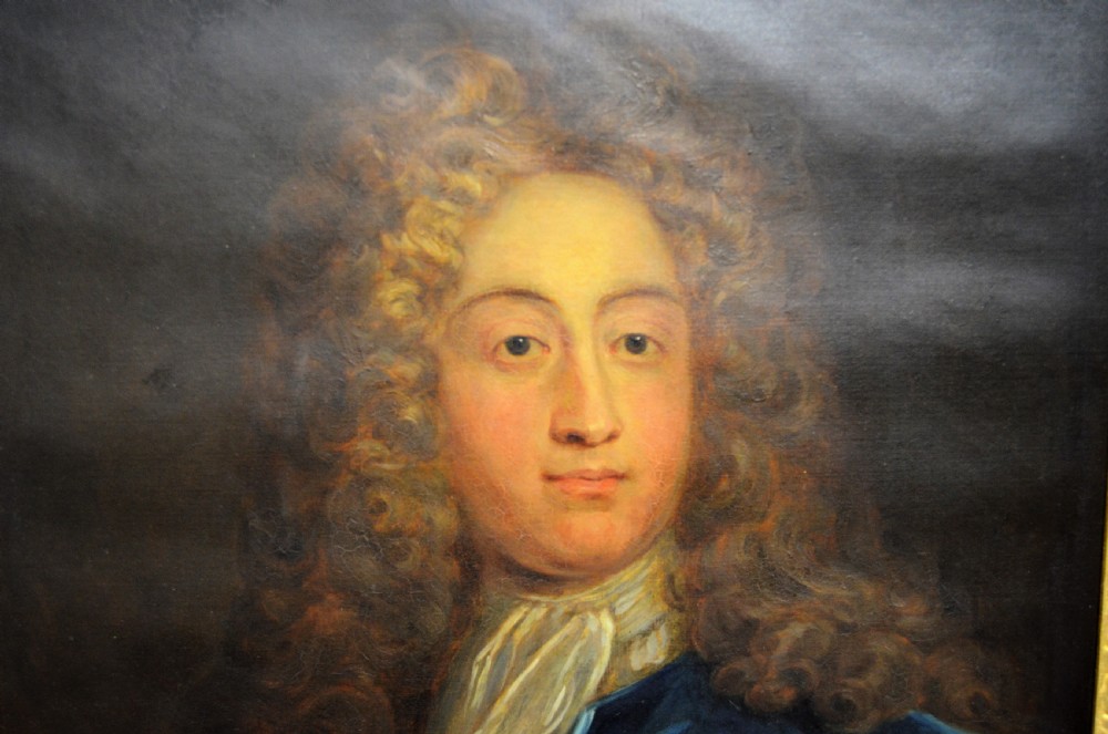 A pair of 19th-century oil portraits depicting male subjects in elaborate attire, enclosed within ornate, heavily carved gilt frames. View III