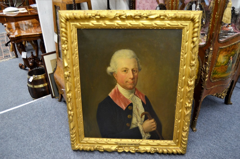 A pair of 19th-century oil portraits depicting male subjects in elaborate attire, enclosed within ornate, heavily carved gilt frames. View IV