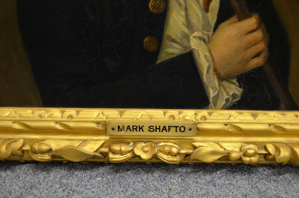 A pair of 19th-century oil portraits depicting male subjects in elaborate attire, enclosed within ornate, heavily carved gilt frames. View VI