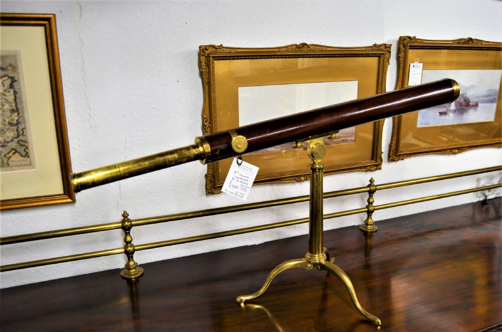 An 18th-century mahogany and brass table telescope by G. Adams of London set on a brass tripod stand.