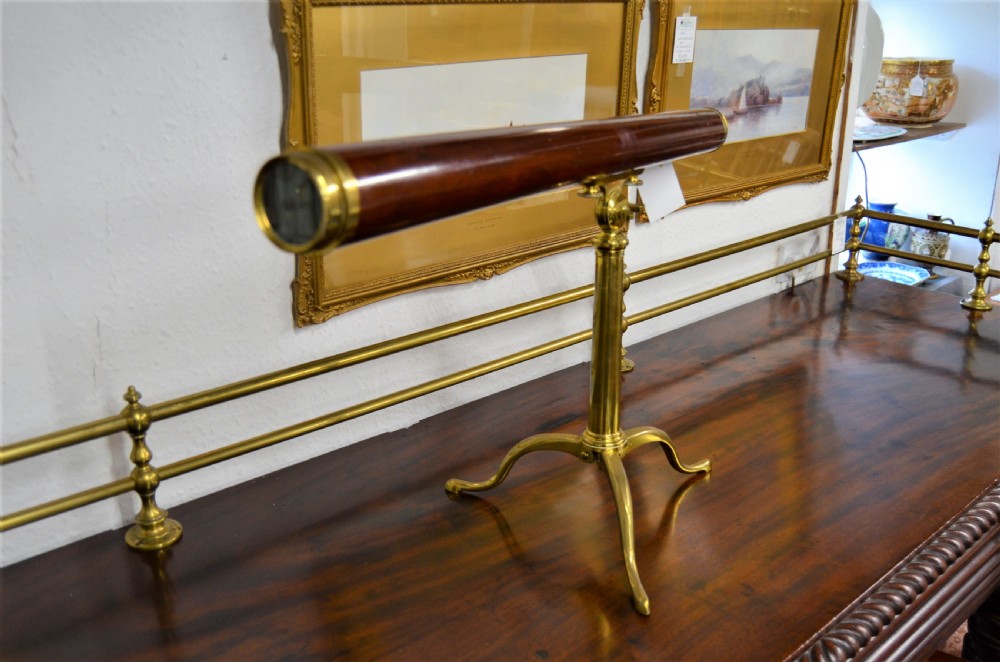 An 18th-century mahogany and brass table telescope by G. Adams of London set on a brass tripod stand. View III