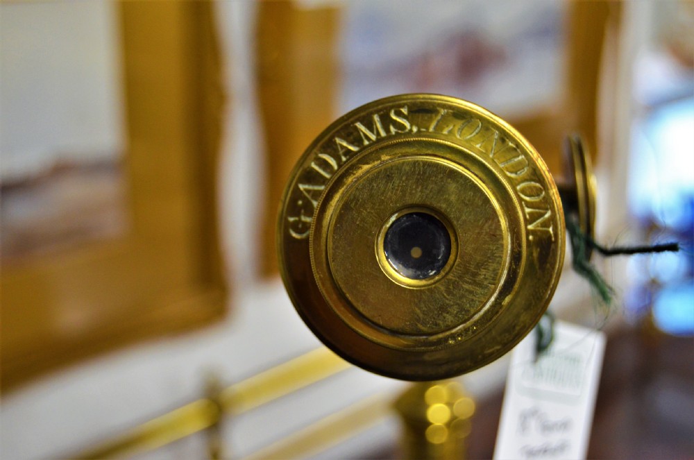 An 18th-century mahogany and brass table telescope by G. Adams of London set on a brass tripod stand. View IV