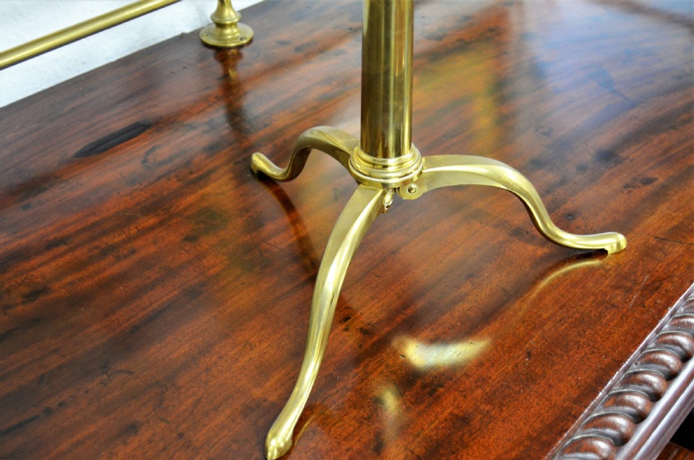 An 18th-century mahogany and brass table telescope by G. Adams of London set on a brass tripod stand. View V