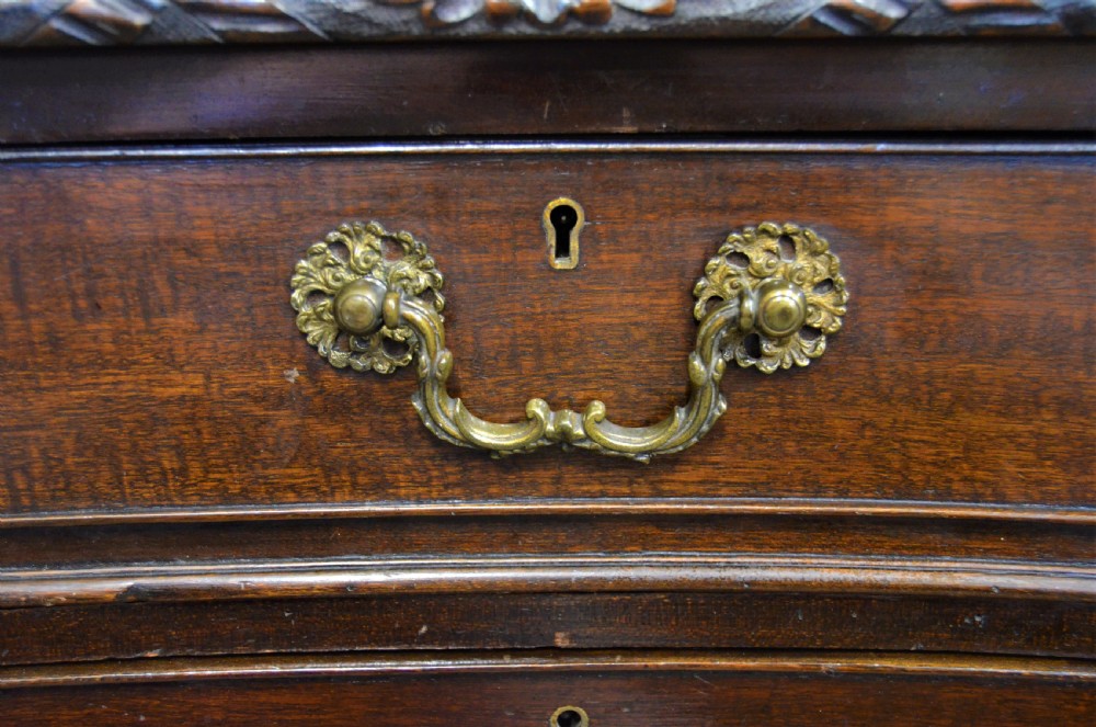 A large mahogany partners desk featuring a three-panel blue leather writing surface, carved edge detailing, brass handles, and twin pedestals with drawers. View V