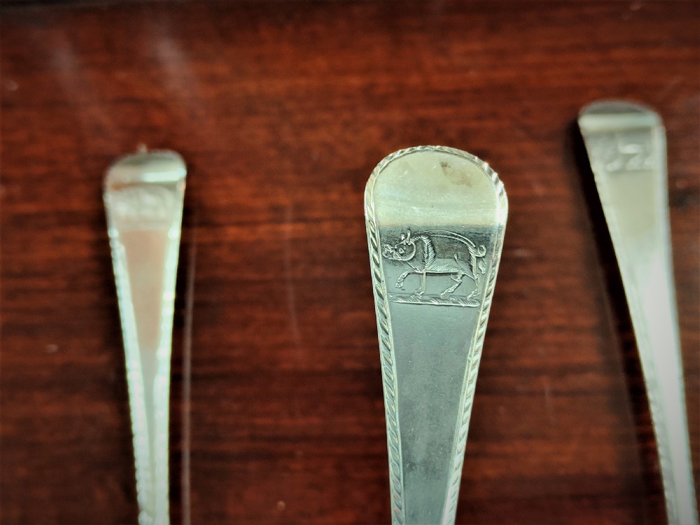 A set of six George III Irish sterling silver tablespoons in the Old English pattern, featuring bright-cut engraved edges and crests on the terminals. View V