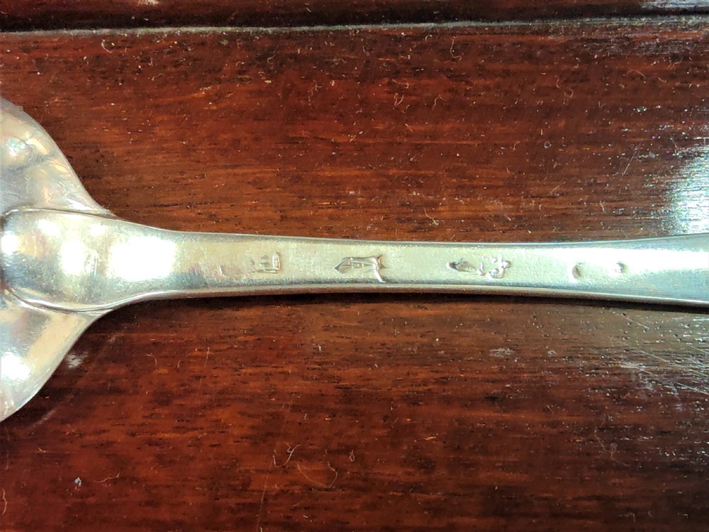 A set of six George III Irish sterling silver tablespoons in the Old English pattern, featuring bright-cut engraved edges and crests on the terminals. View VII