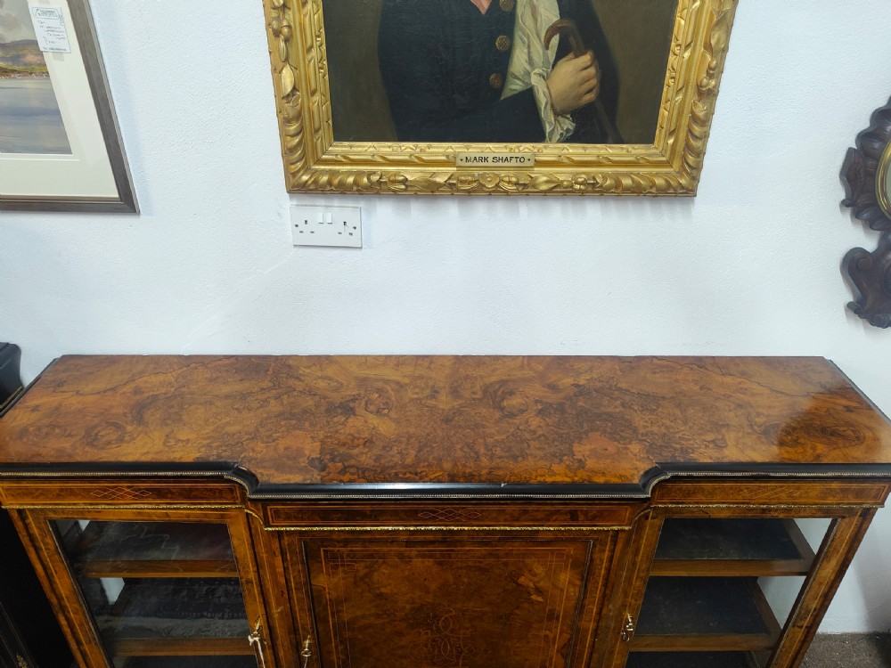 A Victorian burr walnut breakfront credenza featuring central marquetry inlay flanked by two glazed side cabinets. View II