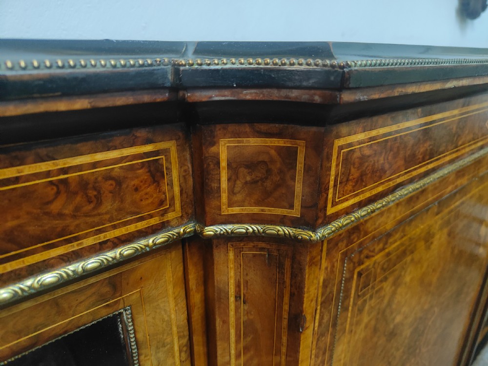 A Victorian burr walnut breakfront credenza featuring central marquetry inlay flanked by two glazed side cabinets. View V