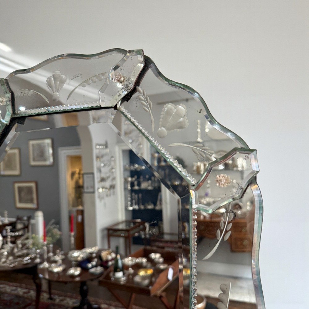 An early 20th-century octagonal Venetian wall mirror featuring an etched glass border with floral engravings, bevelled edges, and glass rosette embellishments. View II