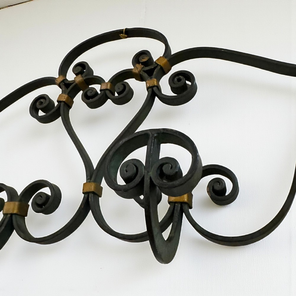 A large wall-mounted French wrought iron coat rack featuring elaborate scrolling motifs and four multi-prong hooks with gold-tone brass accents. View II