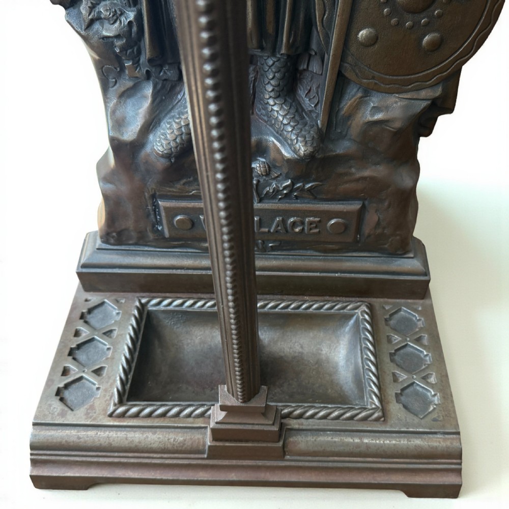 A Victorian cast iron stick stand featuring a relief figure of William Wallace in full armour with a sword, shield, upper retaining framework, and lower drip tray. View IV