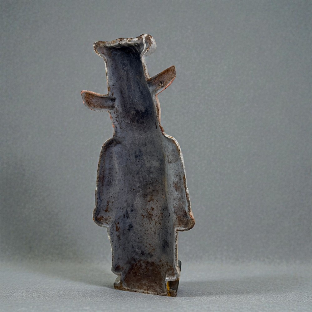A standing painted cast iron pig figure wearing a white chef hat, apron, and neckerchief with surface rust patination. View IV