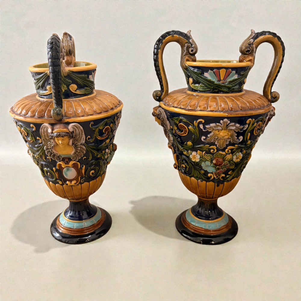 Pair of 19th-century Renaissance Revival majolica ceramic urns with dragon handles, mascaron reliefs, and polychrome glazes. View II