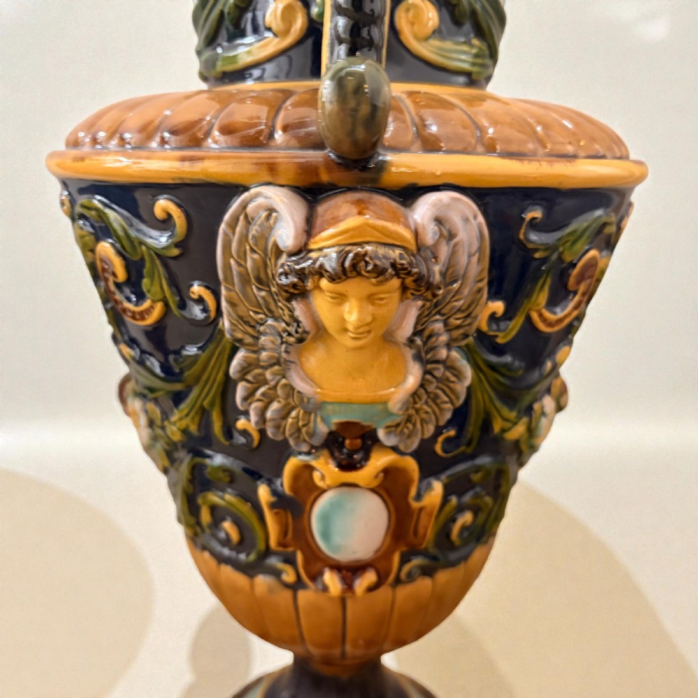 Pair of 19th-century Renaissance Revival majolica ceramic urns with dragon handles, mascaron reliefs, and polychrome glazes. View IV