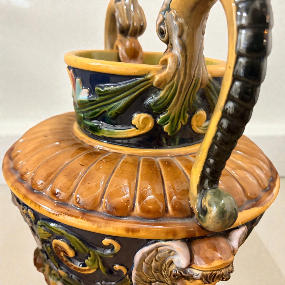 Pair of 19th-century Renaissance Revival majolica ceramic urns with dragon handles, mascaron reliefs, and polychrome glazes. View V