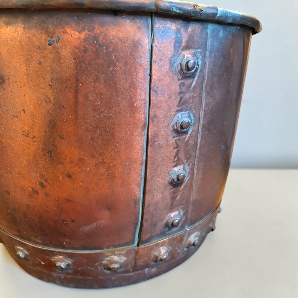 A late 19th-century cylindrical copper vessel featuring hand-riveted seams and a rolled rim. View II