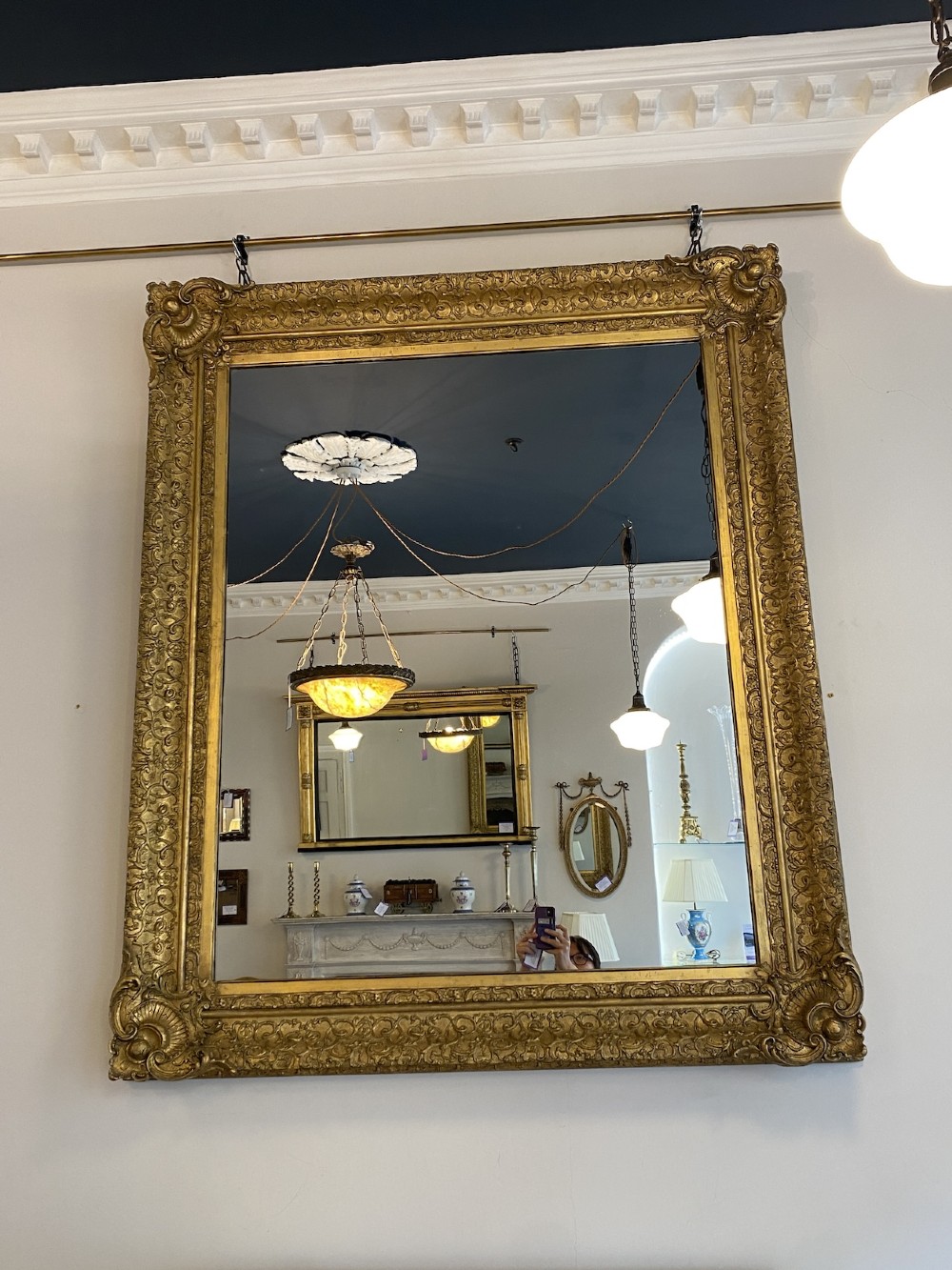 A large rectangular 19th-century wall mirror featuring an ornate gilded frame with carved acanthus leaf corner mouldings. View III